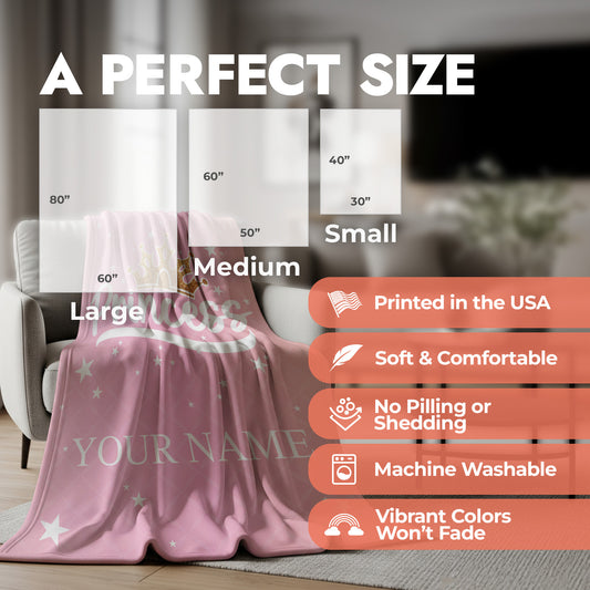 Pink princess blanket spread on an accent chair in the living room with a product size chart and list of product features.