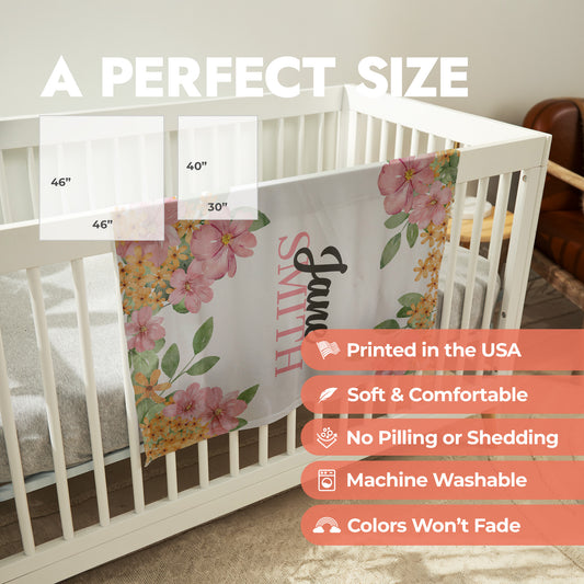 Pink floral baby swaddle is draped over a crib showing product size chart and product features list.
