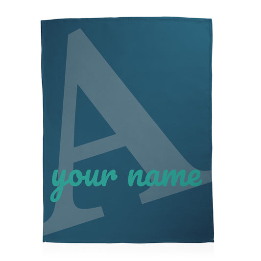Teal blanket with a large letter 'A' and space for 'your name'