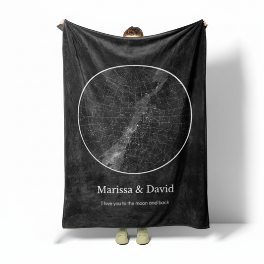 Person holding a 50"x60" personalized star map fleece blanket on a white background.