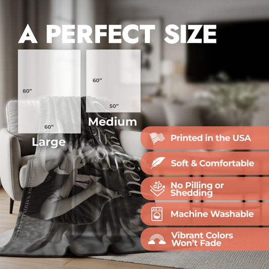 Wedding engagement blanket spread across an accent chair in a living room showing product features and product size chart.