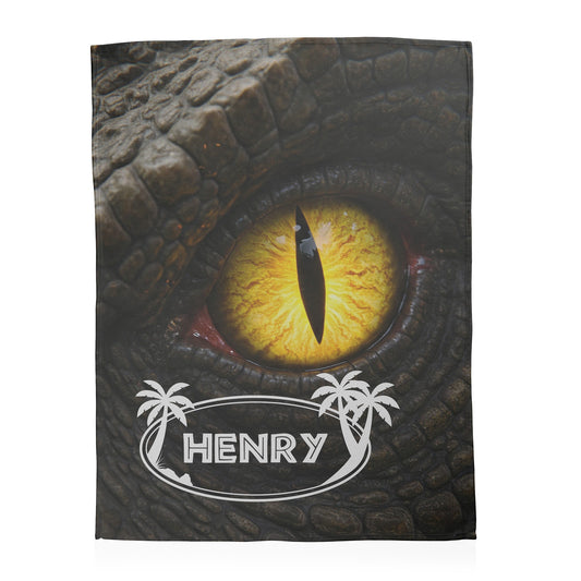 Close up of dinosaur eye with custom name text printed on a fleece blanket.