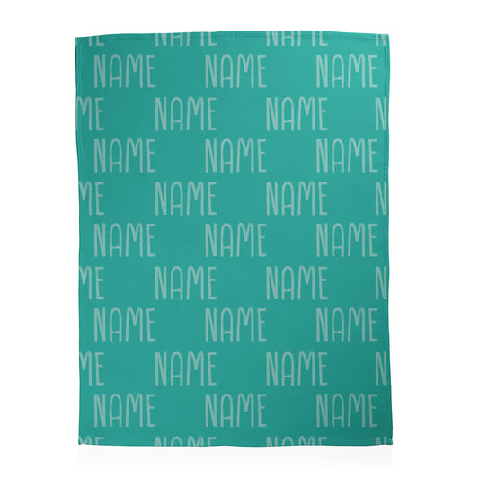 Teal blanket with 'NAME' example text in alternating checkered pattern