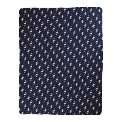 Navy background with white lightning bolt pattern printed on a sherpa fleece backed blanket.