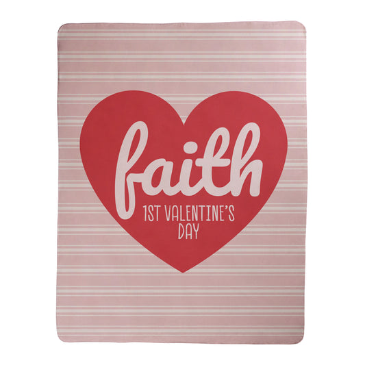 Heart-shaped blanket design with 'faith 1st Valentine's Day' text on a pink and white striped background