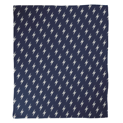 Navy blue background with white lightning bolt pattern printed on a minky fleece blanket.