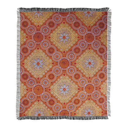 Mandala inspired geometric patterns with terracotta and gold colors printed in a cotton/polyester blend throw with decorative fringed edges.