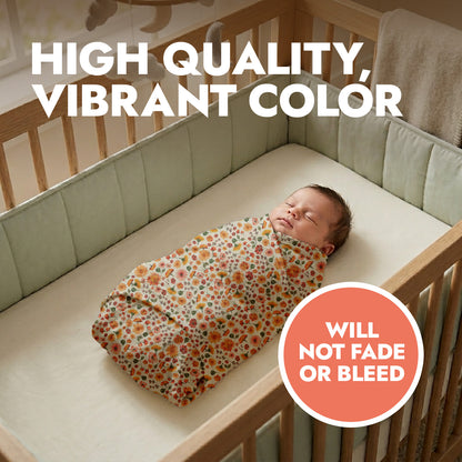 Newborn baby swaddled in a floral blanket in a crib with text about fabric quality.