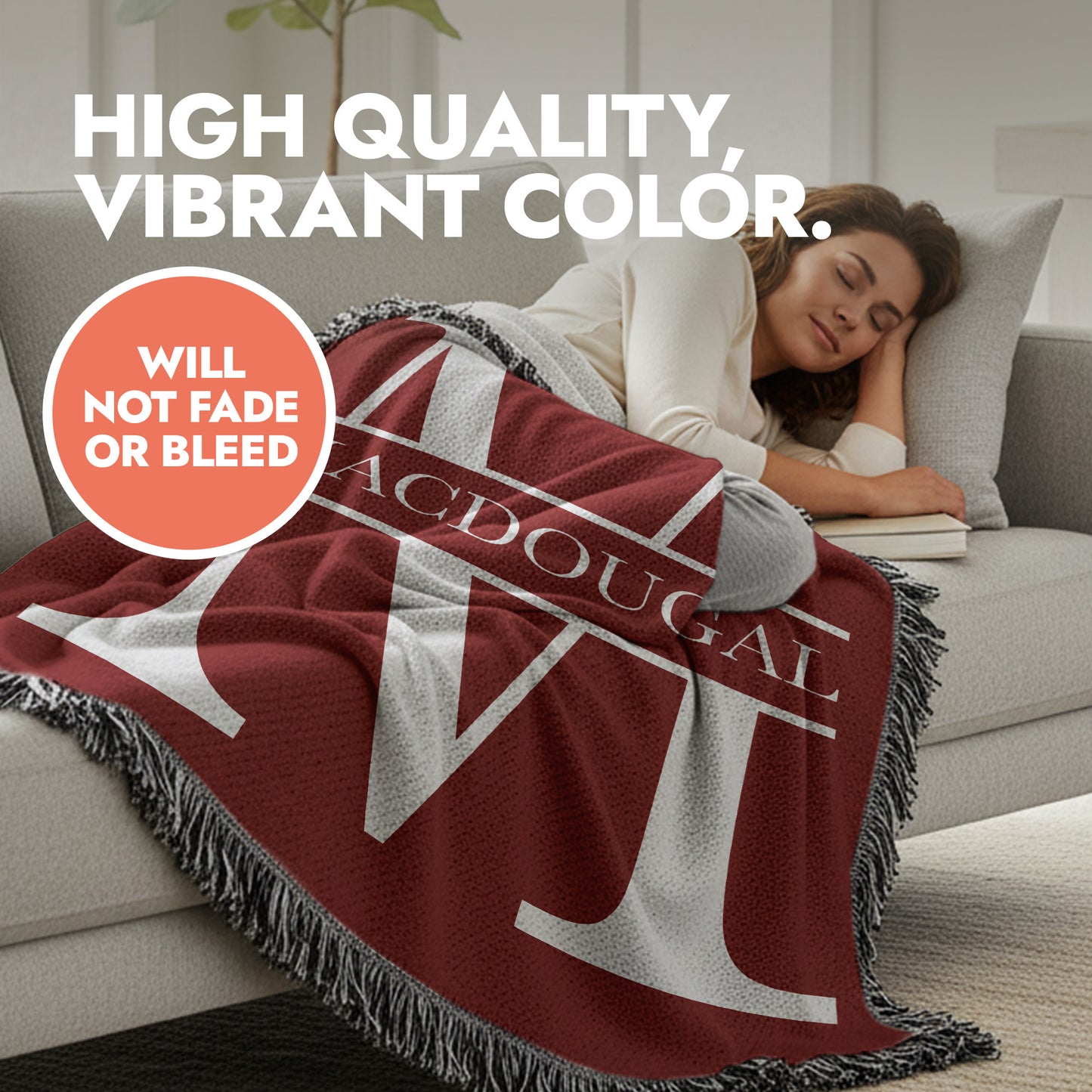 Woman lying on a couch with a red blanket featuring decorative fringed edges