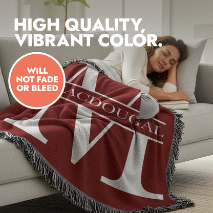 Woman lying on a couch with a red blanket featuring decorative fringed edges